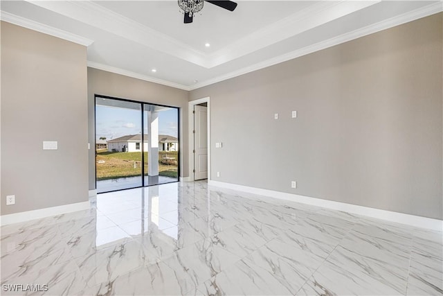 empty room with ornamental molding, a raised ceiling, and ceiling fan