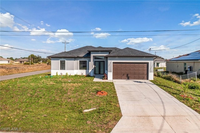 view of front of property with a garage and a front lawn