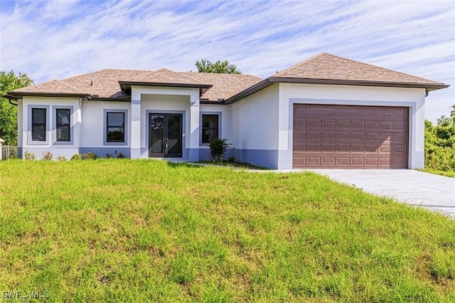 view of front of home with a garage and a front lawn