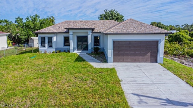 view of front of property featuring a garage and a front lawn