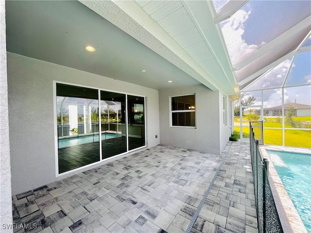 view of patio / terrace featuring glass enclosure and an outdoor pool