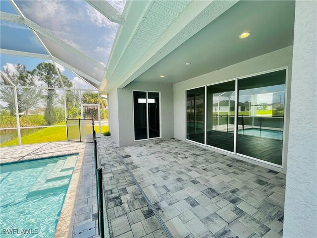 view of patio featuring glass enclosure and an outdoor pool