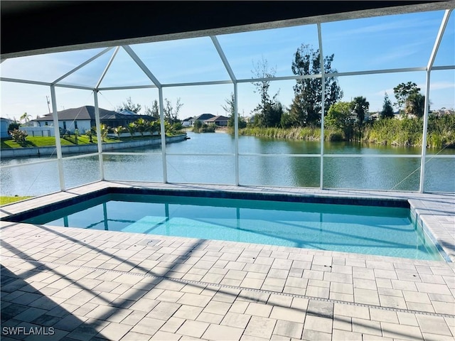 outdoor pool featuring a water view, a lanai, and a patio