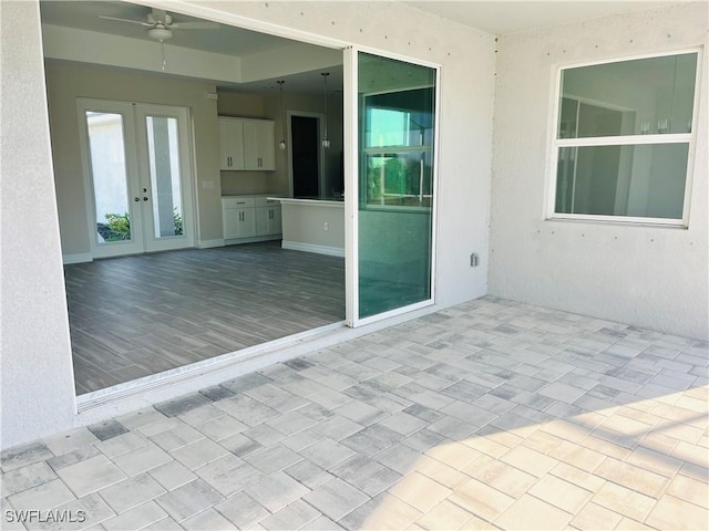 view of patio featuring a ceiling fan and french doors