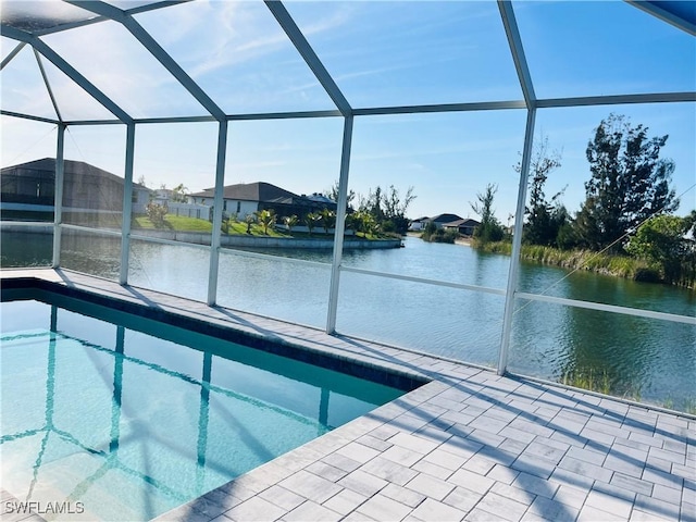 view of swimming pool featuring a water view, glass enclosure, and a patio area