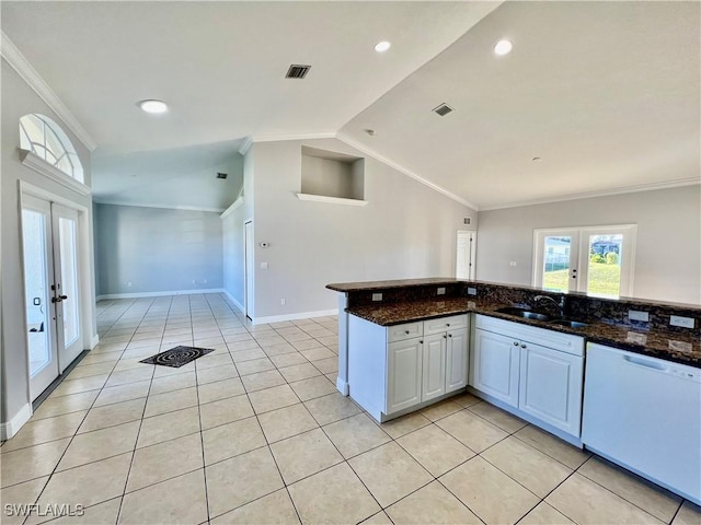 kitchen with sink, dark stone countertops, white cabinets, white dishwasher, and french doors