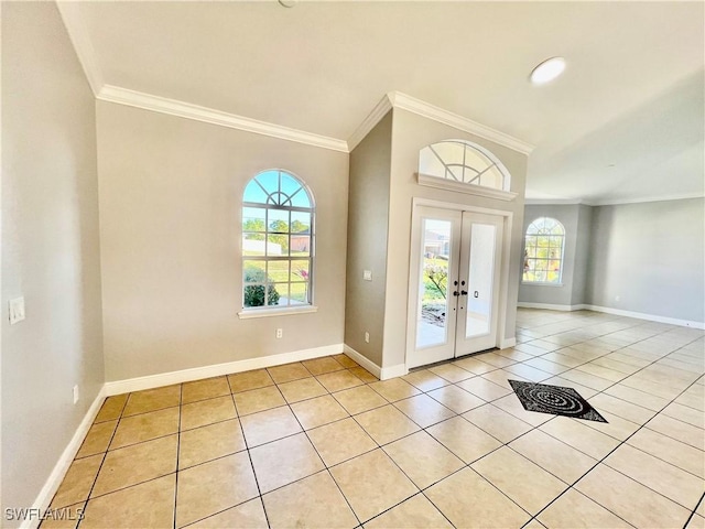 entryway featuring crown molding, light tile patterned floors, and french doors