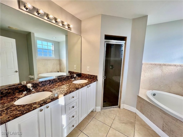 bathroom with tile patterned floors, independent shower and bath, and vanity