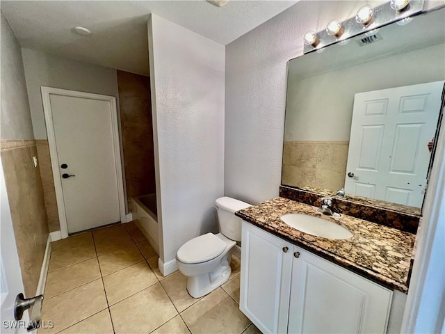 full bathroom with bathtub / shower combination, tile patterned floors, toilet, and vanity