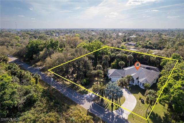 drone / aerial view featuring a forest view