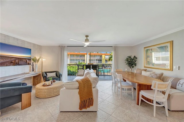 living room featuring light tile patterned floors, crown molding, and ceiling fan