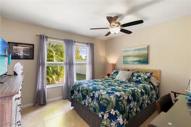 tiled bedroom featuring ceiling fan