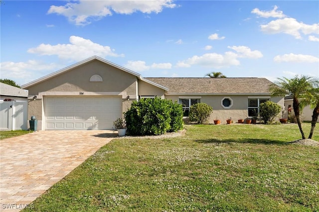 single story home with a garage and a front lawn