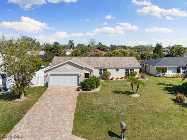 ranch-style home featuring a garage and a front lawn