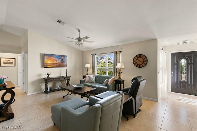 living room featuring ceiling fan, lofted ceiling, and light tile patterned floors