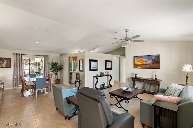 tiled living room with ceiling fan and vaulted ceiling