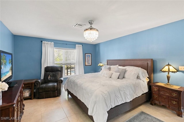 tiled bedroom with a notable chandelier