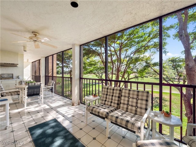 unfurnished sunroom featuring ceiling fan