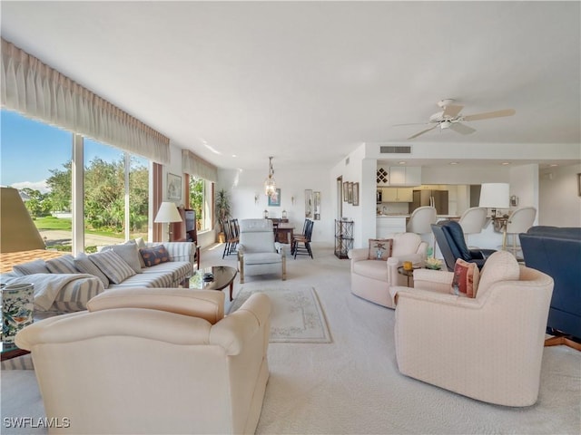 living room with ceiling fan and light carpet