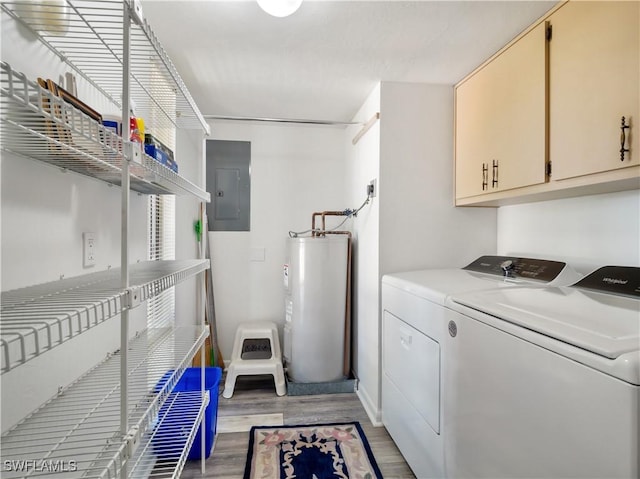 laundry room featuring washer and dryer, water heater, cabinets, electric panel, and light hardwood / wood-style flooring