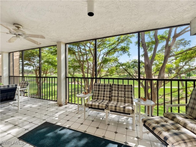 unfurnished sunroom featuring ceiling fan