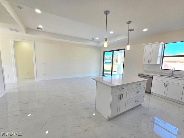 kitchen with sink, dishwasher, a raised ceiling, a kitchen island, and white cabinets