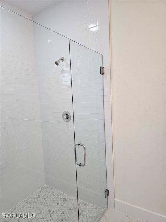 bathroom with a shower with shower door