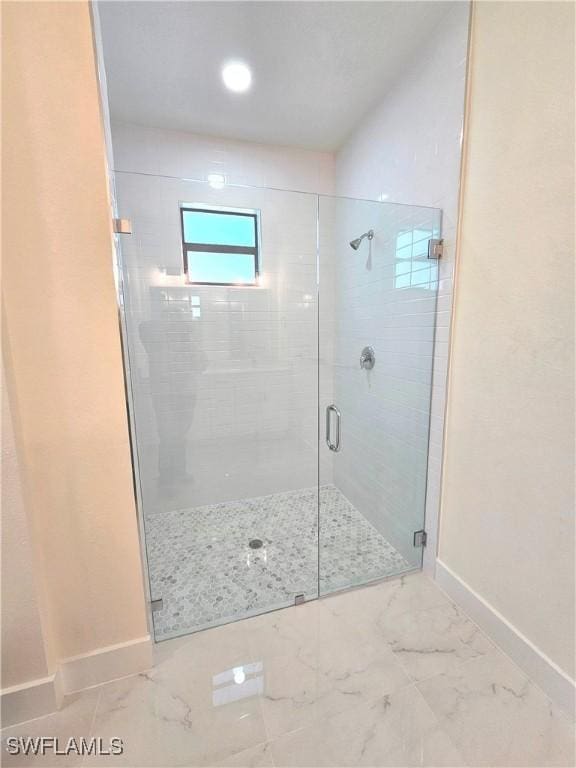 bathroom with a shower with shower door