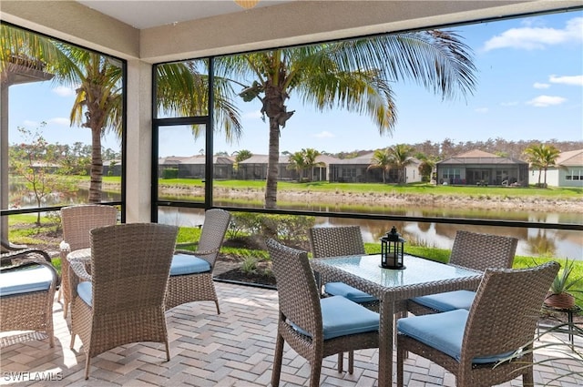 sunroom / solarium with a water view