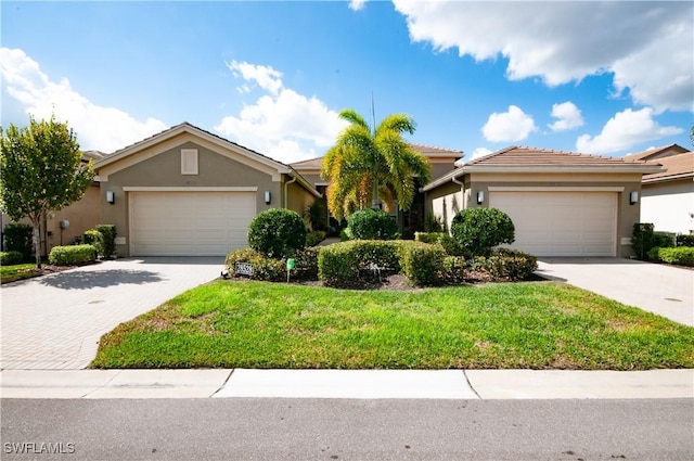 view of front of house with a garage and a front yard