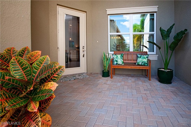 view of exterior entry featuring a patio