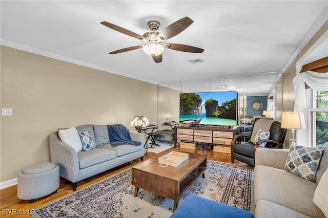 living room featuring ceiling fan, crown molding, and hardwood / wood-style floors