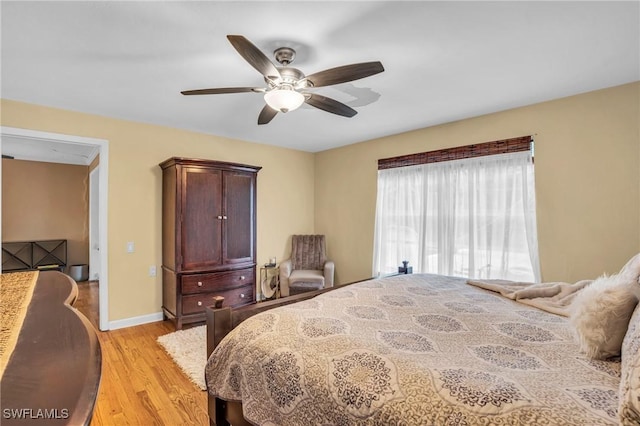 bedroom with ceiling fan and light hardwood / wood-style floors