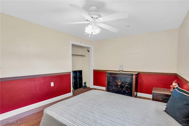 bedroom with ceiling fan, a closet, and hardwood / wood-style floors