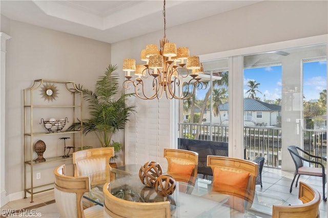 dining room featuring an inviting chandelier and a tray ceiling