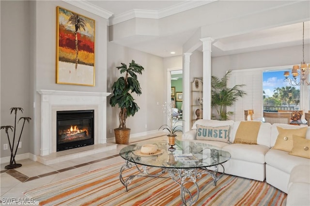 living room with ornamental molding, a chandelier, and ornate columns