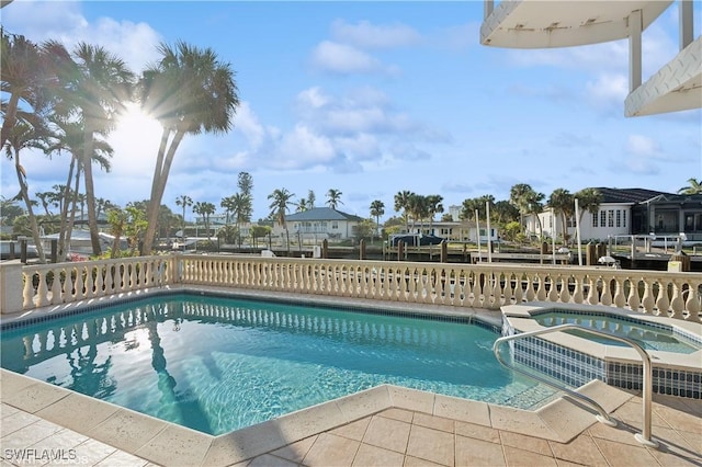 view of pool with an in ground hot tub