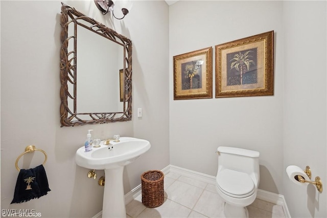 bathroom featuring tile patterned floors, toilet, and sink