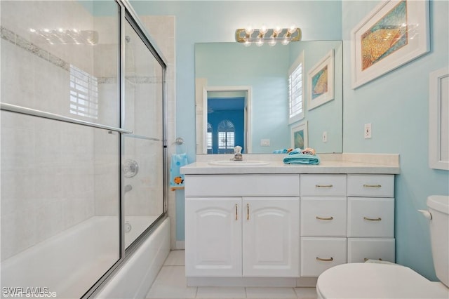 full bathroom with vanity, bath / shower combo with glass door, and toilet