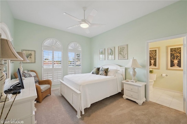 carpeted bedroom with ceiling fan and connected bathroom