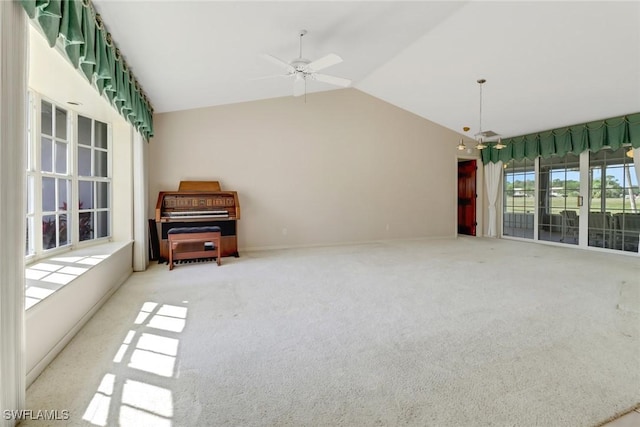 living room featuring vaulted ceiling, carpet floors, and ceiling fan