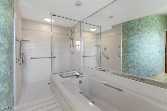 bathroom with tile patterned flooring and shower with separate bathtub