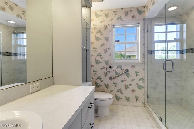 bathroom featuring an enclosed shower, vanity, and toilet