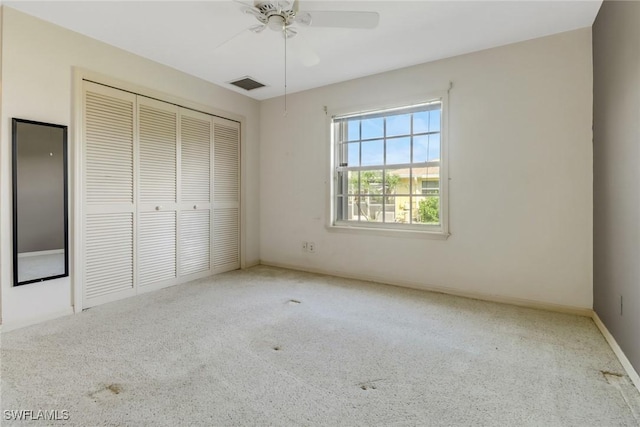 unfurnished bedroom with light colored carpet, a closet, and ceiling fan