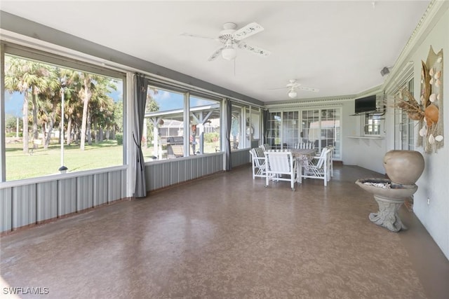 unfurnished sunroom with ceiling fan