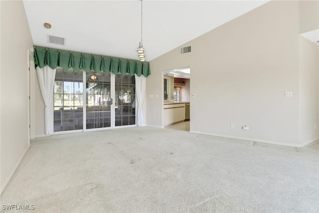 carpeted empty room featuring lofted ceiling