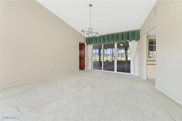 carpeted empty room with vaulted ceiling