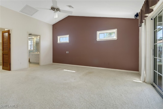 carpeted spare room featuring lofted ceiling and ceiling fan