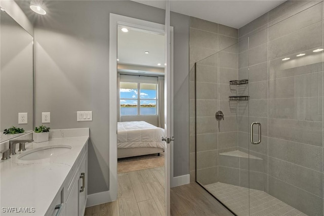 bathroom with an enclosed shower, vanity, and hardwood / wood-style flooring