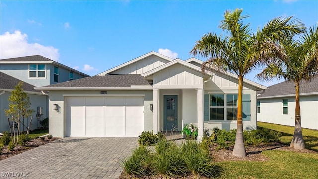 16142 Preservation Blvd, Punta Gorda, FL 33982 - view of front of home featuring board and batten siding, stucco siding, a garage, and decorative driveway